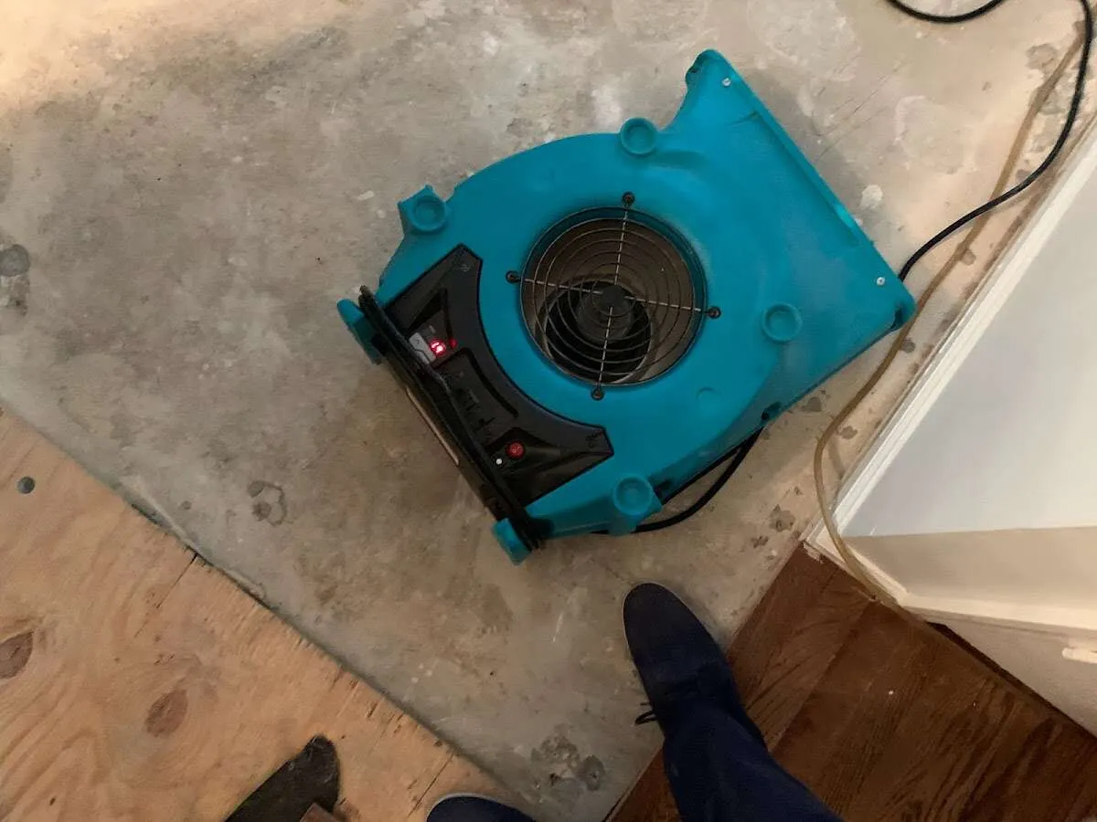 Air mover drying subfloor during Leak Detection & Repair in Granby